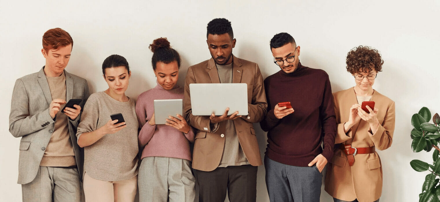 A group of people looking at their phones.