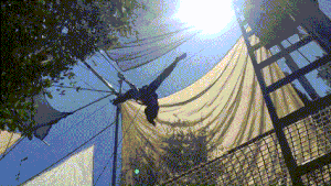 An individual flying a kite with the help of an automatic device.