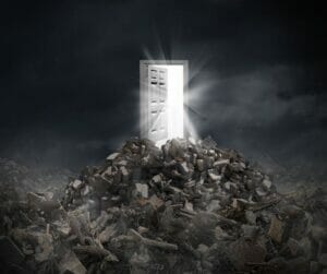 An open door in the middle of a pile of rubble.