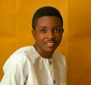 A young man in a white shirt is smiling, radiating families' emotional wellness.